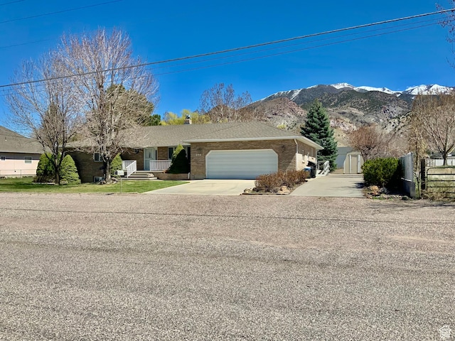 single story home featuring a mountain view and a garage