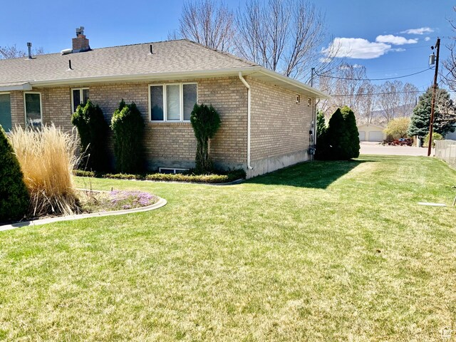 view of side of home featuring a lawn
