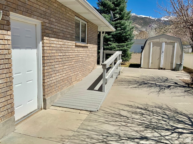 exterior space with a shed and a mountain view