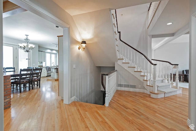 5845 Kerry Cir, Murray, UT 84107 - stairs featuring a notable chandelier and wood-type flooring