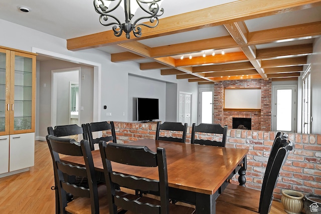 5845 Kerry Cir, Murray, UT 84107 - dining room featuring a notable chandelier, coffered ceiling, a fireplace, beamed ceiling, and light wood-type flooring