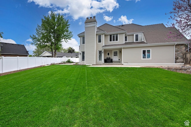5845 Kerry Cir, Murray, UT 84107 - back of property with a lawn and a patio