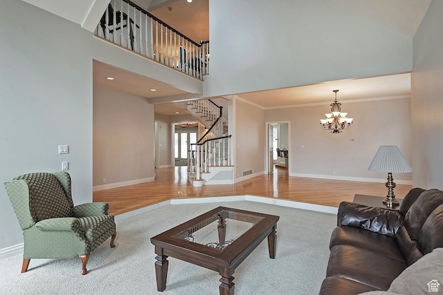 5845 Kerry Cir, Murray, UT 84107 - living room with crown molding, hardwood / wood-style flooring, a towering ceiling, and a notable chandelier
