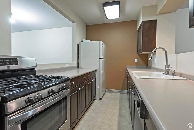 5845 Kerry Cir, Murray, UT 84107 - kitchen with dark brown cabinetry, stainless steel appliances, and sink
