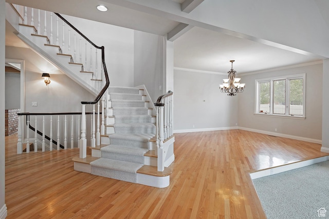 5845 Kerry Cir, Murray, UT 84107 - stairway with an inviting chandelier, wood-type flooring, and ornamental molding