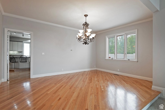 5845 Kerry Cir, Murray, UT 84107 - unfurnished room with an inviting chandelier, light hardwood / wood-style flooring, and ornamental molding