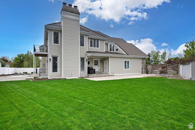 5845 Kerry Cir, Murray, UT 84107 - rear view of property with a balcony, a patio, and a lawn