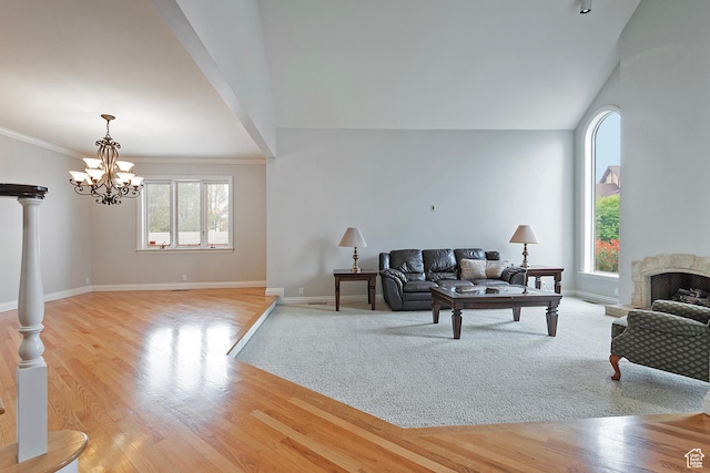 5845 Kerry Cir, Murray, UT 84107 - living room with a notable chandelier, crown molding, and light hardwood / wood-style floors
