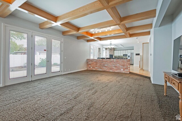 5845 Kerry Cir, Murray, UT 84107 - unfurnished living room with a notable chandelier, carpet, french doors, and coffered ceiling