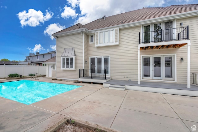 5845 Kerry Cir, Murray, UT 84107 - rear view of house featuring a patio, a balcony, and a fenced in pool