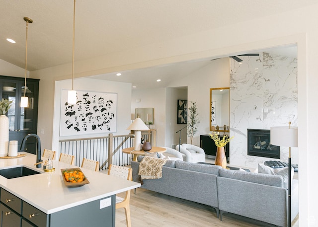 908 E 430 N Unit 18, Salem, UT 84653 - living room with light hardwood / wood-style floors, vaulted ceiling, sink, and a fireplace