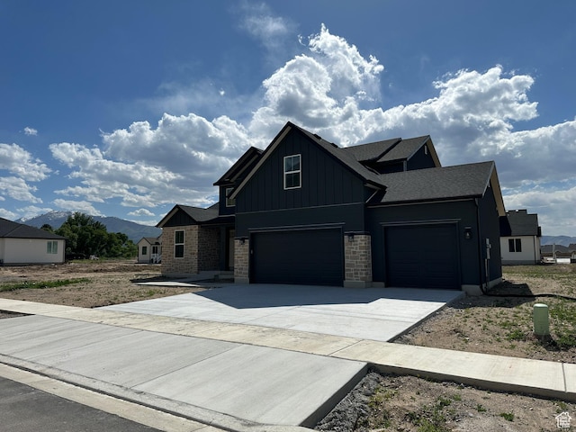325 N 1040 E Unit 26, Salem, UT 84653 - view of front of house with board and batten siding, driveway, a garage, and roof with shingles