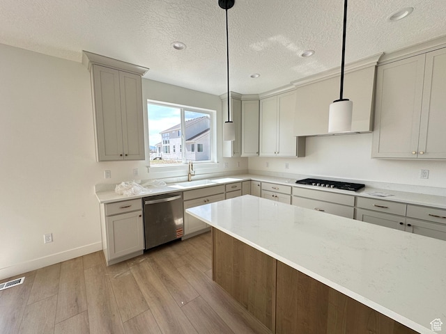 325 N 1040 E Unit 26, Salem, UT 84653 - kitchen with dishwasher, gas cooktop, a sink, light wood-style flooring, and a textured ceiling