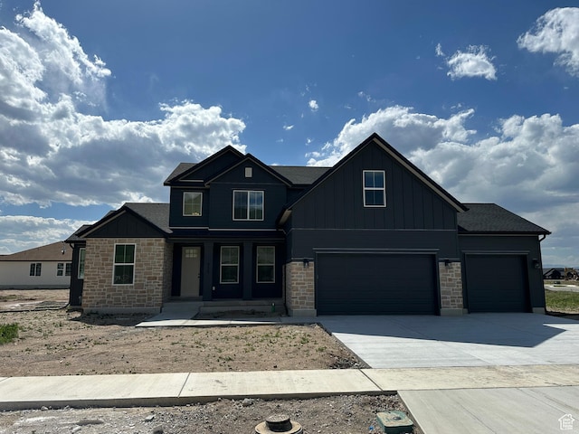 325 N 1040 E Unit 26, Salem, UT 84653 - view of front of property with board and batten siding, driveway, an attached garage, and stone siding