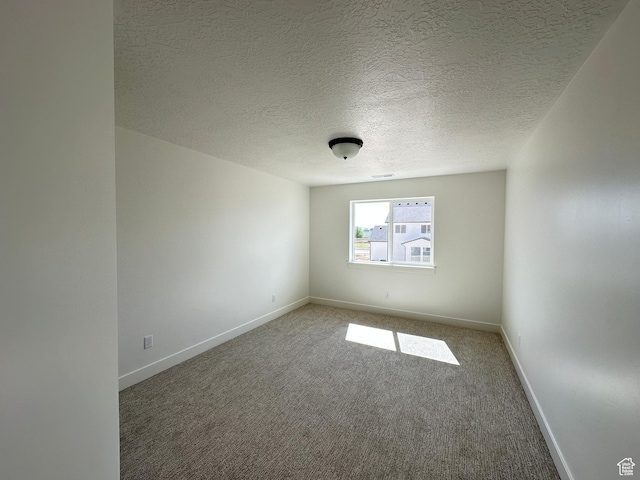 325 N 1040 E Unit 26, Salem, UT 84653 - empty room with carpet floors, baseboards, and a textured ceiling