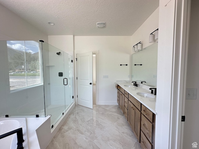 325 N 1040 E Unit 26, Salem, UT 84653 - bathroom featuring a textured ceiling, double vanity, a stall shower, marble finish floors, and a tub