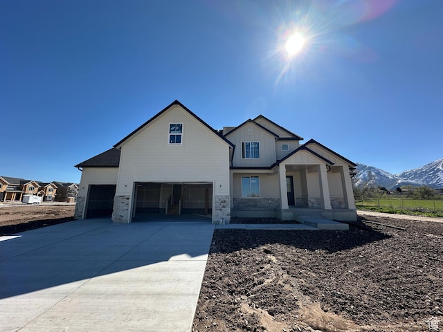 1412 N 290 E Unit 5, Salem, UT 84653 - view of front of house featuring a mountain view, board and batten siding, covered porch, driveway, and stone siding