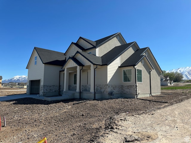 1412 N 290 E Unit 5, Salem, UT 84653 - view of front facade featuring a porch, a mountain view, stone siding, and a garage
