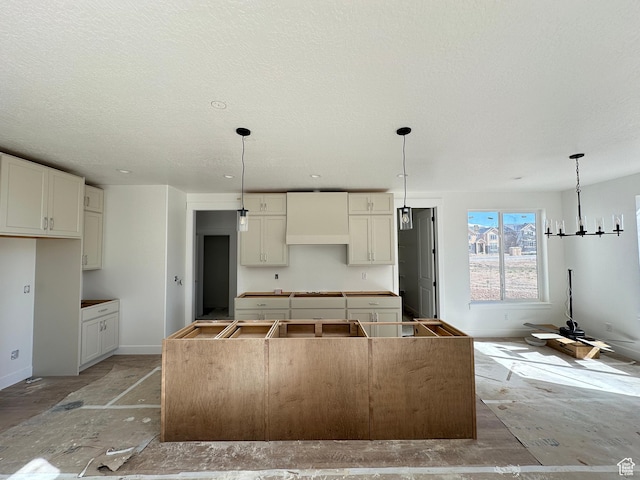 1412 N 290 E Unit 5, Salem, UT 84653 - kitchen featuring a kitchen island, baseboards, a textured ceiling, decorative light fixtures, and a chandelier
