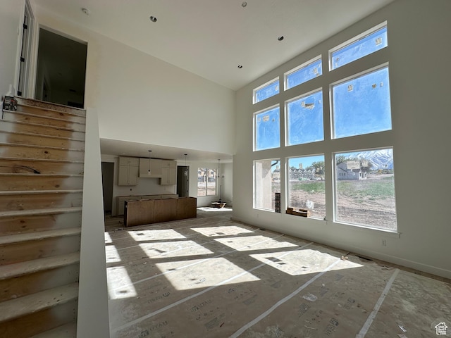1412 N 290 E Unit 5, Salem, UT 84653 - unfurnished living room featuring a high ceiling and stairs