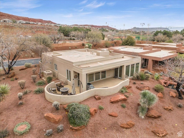 2255 N Tuweap Dr Unit 45, St George, UT 84770 - rear view of house with a patio area, a mountain view, and central AC