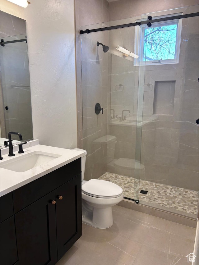 2255 N Tuweap Dr Unit 45, St George, UT 84770 - full bathroom featuring a stall shower, vanity, and toilet