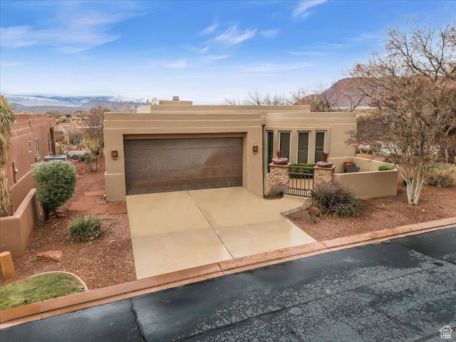 2255 N Tuweap Dr Unit 45, St George, UT 84770 - southwest-style home featuring an attached garage, a mountain view, fence, concrete driveway, and stucco siding