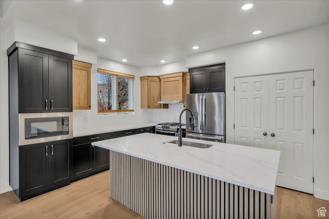 2255 N Tuweap Dr Unit 45, St George, UT 84770 - kitchen featuring recessed lighting, appliances with stainless steel finishes, light wood-type flooring, light stone countertops, and a center island with sink