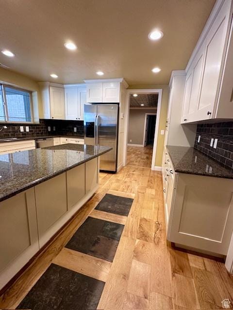 969 N 1200 W, Marriott Slaterville, UT 84404 - kitchen with dark stone counters, light wood-type flooring, stainless steel appliances, and white cabinets