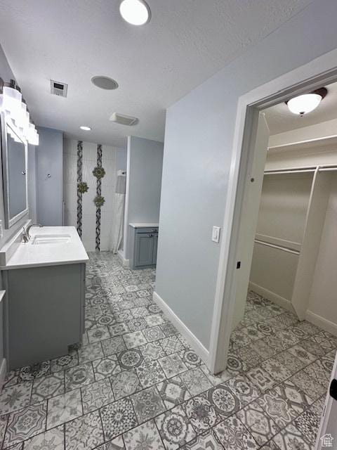 969 N 1200 W, Marriott Slaterville, UT 84404 - bathroom featuring a textured ceiling and vanity