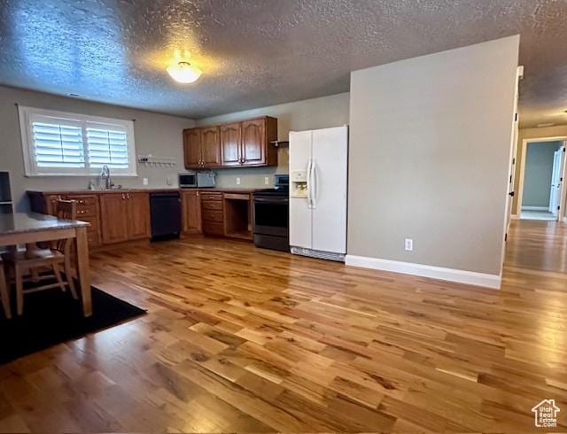 969 N 1200 W, Marriott Slaterville, UT 84404 - kitchen with dishwasher, white fridge with ice dispenser, stove, and light wood-type flooring