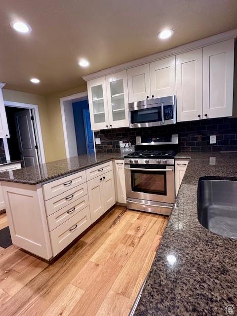 969 N 1200 W, Marriott Slaterville, UT 84404 - kitchen featuring light wood-type flooring, appliances with stainless steel finishes, and white cabinets