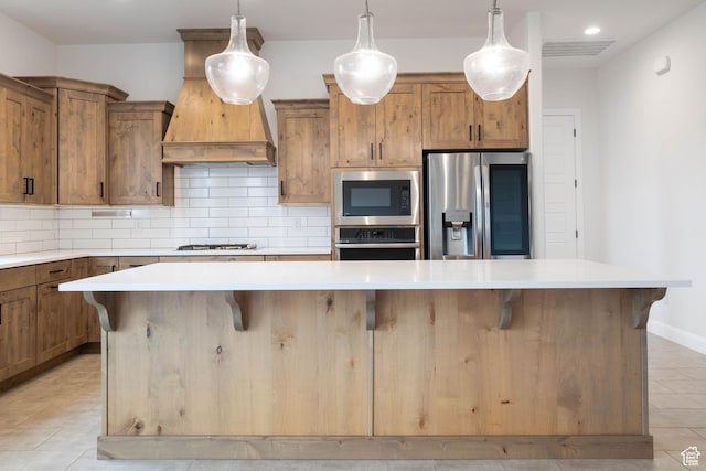 617 W 280 S, Ivins, UT 84738 - kitchen featuring stainless steel appliances, a breakfast bar, a kitchen island, backsplash, and pendant lighting