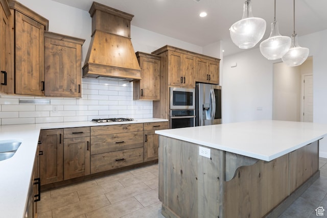 617 W 280 S, Ivins, UT 84738 - kitchen with hanging light fixtures, custom range hood, appliances with stainless steel finishes, a kitchen breakfast bar, and decorative backsplash