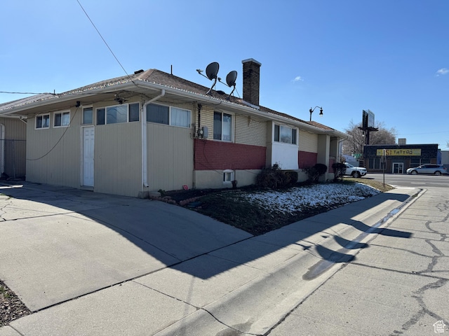 1135 S State St E, Salt Lake City, UT 84111 - view of home's exterior featuring brick siding and a chimney