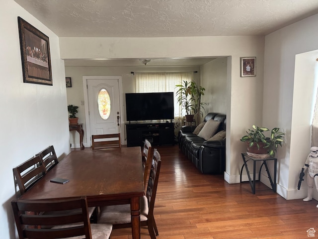 1135 S State St E, Salt Lake City, UT 84111 - dining area with a textured ceiling, baseboards, and hardwood / wood-style floors