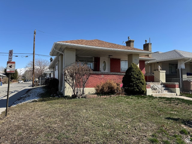 1135 S State St E, Salt Lake City, UT 84111 - view of front of property with brick siding, a front lawn, and a chimney