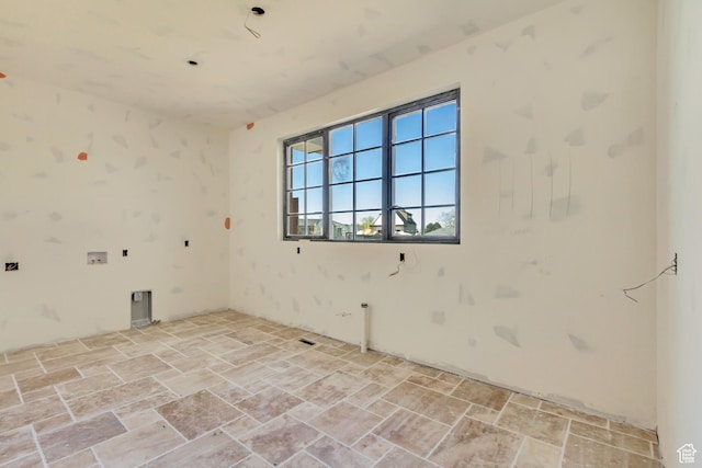 spare room with stone tile flooring