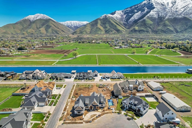 aerial view with a water and mountain view and a residential view