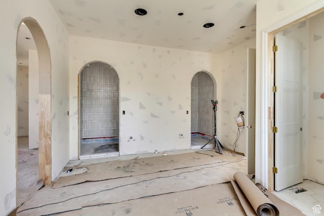spare room with arched walkways