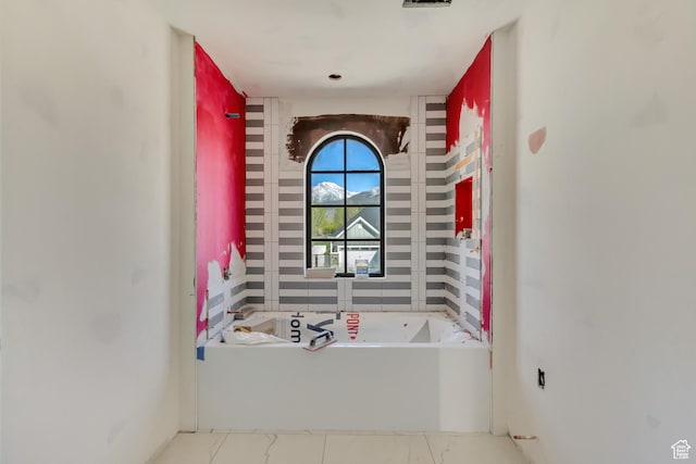 bathroom with a garden tub