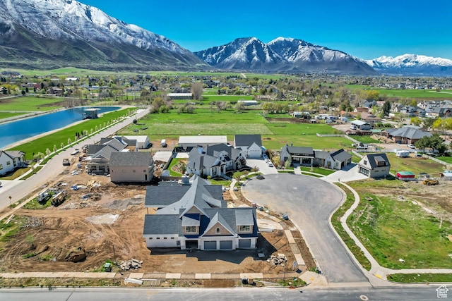 birds eye view of property with a water and mountain view and a residential view