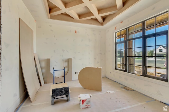 interior space with coffered ceiling, a wealth of natural light, and beam ceiling