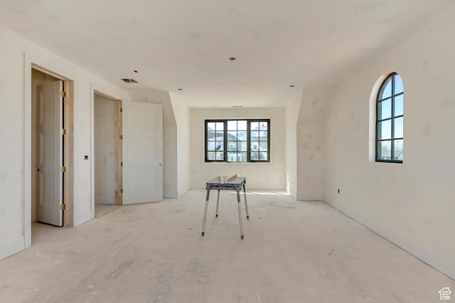 unfurnished room featuring visible vents
