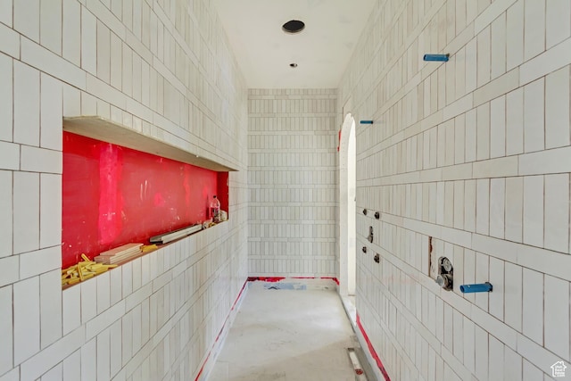 bathroom with tile walls