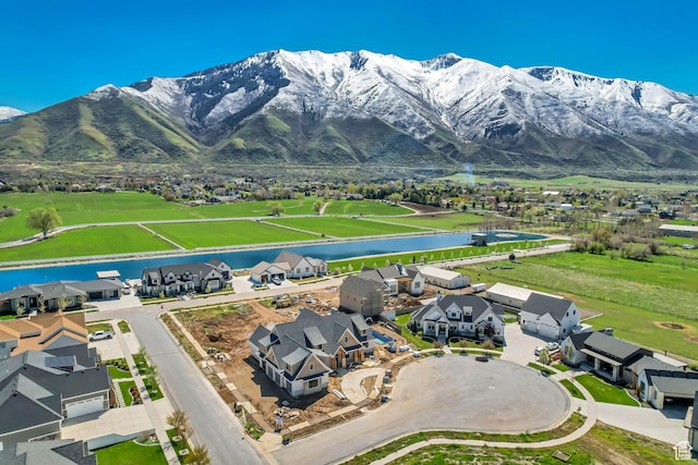 aerial view featuring a water and mountain view and a residential view