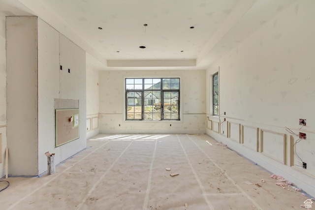 unfurnished living room with a tray ceiling