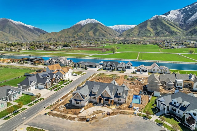 aerial view with a water and mountain view and a residential view