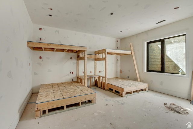 bedroom featuring concrete floors and visible vents