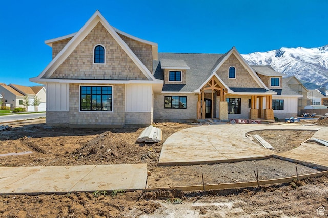 view of front of home featuring a mountain view, board and batten siding, and roof with shingles